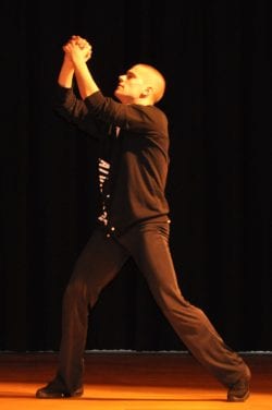 One member of the Alvin Ailey American Dance group performing for Cotting students and staff in a participatory and engaging show