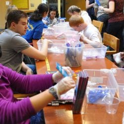 Upper School students packaging partyware, assemble goody bags, bake cupcakes, wrap gifts and birthday boxes, and deliver prepared boxes to shelters with Cotting staff