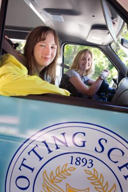 Laura is responsible for Project Bridges, our students' off campus internship program. She is driving a Cotting school bus driving a student to the internship program.