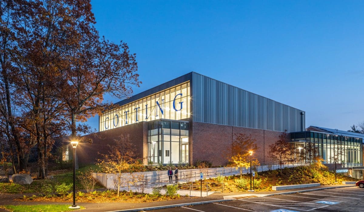 The outside of Cotting School at night