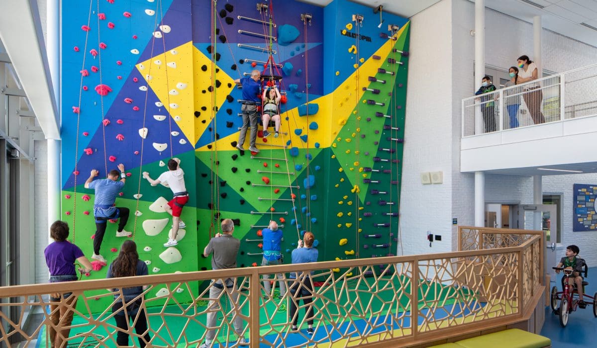 Fully accessible rock climbing wall at Cotting with students climbing