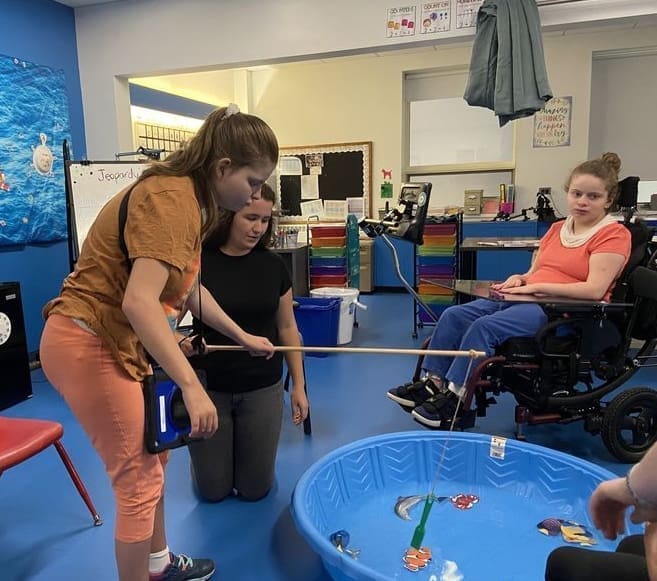 Students doing a fishing simulation
